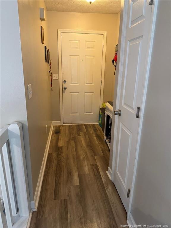 6651 Brookshire St, Fayetteville, NC 28314 - doorway featuring wood finished floors, a textured ceiling, and baseboards