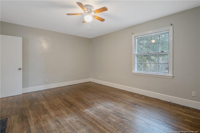 spare room with ceiling fan, wood finished floors, and baseboards