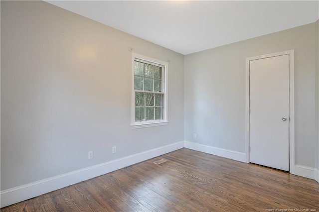 empty room with wood finished floors and baseboards