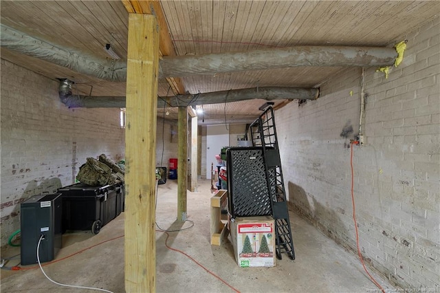 unfinished basement featuring brick wall