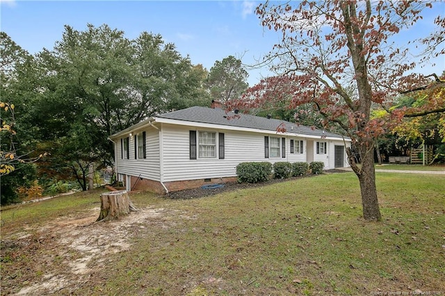 view of front of home with crawl space, a front lawn, and a chimney
