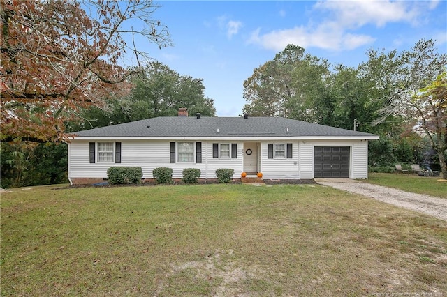 ranch-style home with a garage, driveway, and a front lawn