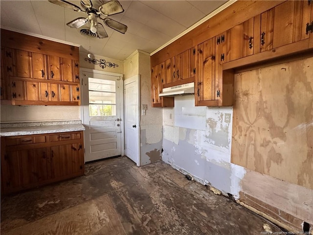 6695 Maxwell Rd, Stedman, NC 28391 - kitchen with brown cabinets, under cabinet range hood, ceiling fan, and light countertops