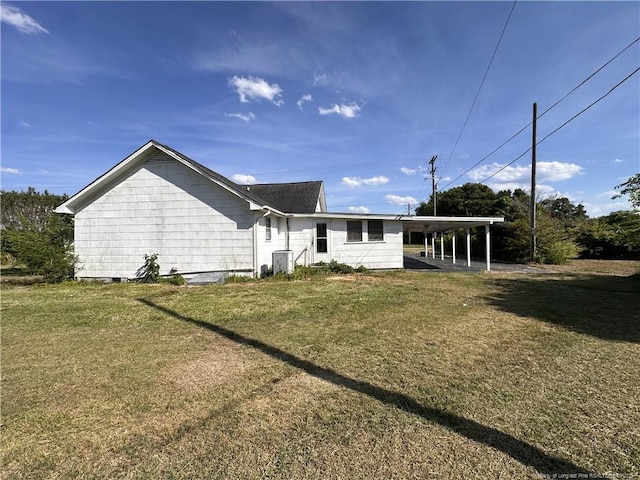 6695 Maxwell Rd, Stedman, NC 28391 - back of house featuring a lawn, a carport, and central AC unit