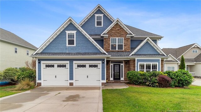 4323 Saleeby Way, Fayetteville, NC 28306 - craftsman inspired home featuring concrete driveway, a front lawn, a garage, and stone siding