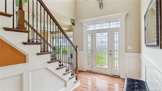 4323 Saleeby Way, Fayetteville, NC 28306 - entryway with plenty of natural light, wood finished floors, a towering ceiling, a decorative wall, and wainscoting