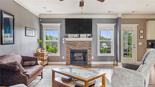 4323 Saleeby Way, Fayetteville, NC 28306 - living room with plenty of natural light, a ceiling fan, a fireplace, light wood-type flooring, and crown molding