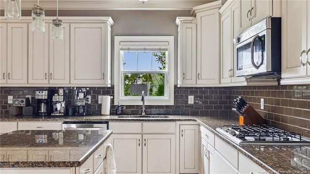 4323 Saleeby Way, Fayetteville, NC 28306 - kitchen with appliances with stainless steel finishes, a sink, tasteful backsplash, dark stone countertops, and white cabinetry