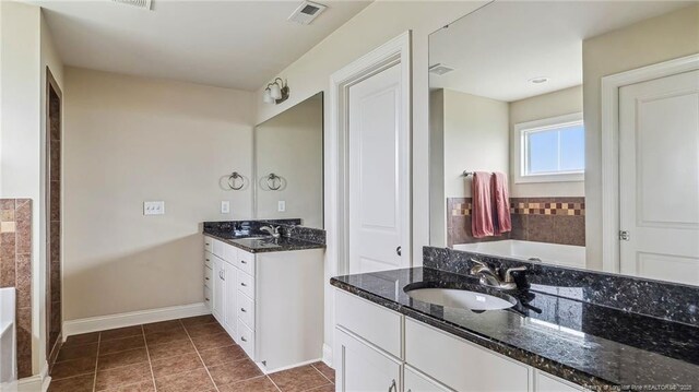 4323 Saleeby Way, Fayetteville, NC 28306 - full bathroom featuring a garden tub, tile patterned flooring, baseboards, and two vanities