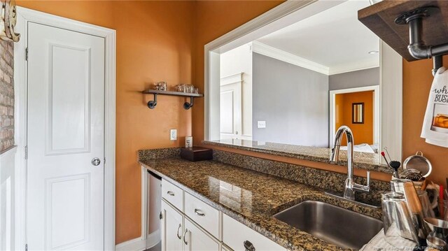 4323 Saleeby Way, Fayetteville, NC 28306 - kitchen featuring a sink, dark stone counters, white cabinets, and crown molding