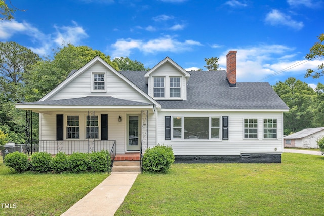 302 Hester St, Knightdale, NC 27545 - view of front facade with a front lawn, a shingled roof, covered porch, and a chimney
