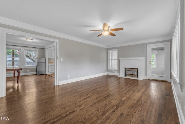 302 Hester St, Knightdale, NC 27545 - unfurnished living room featuring plenty of natural light, ceiling fan, dark wood-style floors, baseboards, and ornamental molding
