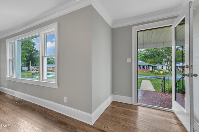 302 Hester St, Knightdale, NC 27545 - doorway to outside with ornamental molding, baseboards, and wood finished floors