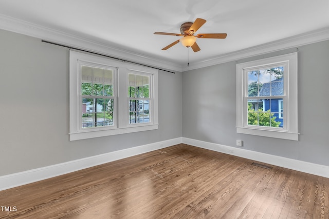 302 Hester St, Knightdale, NC 27545 - spare room featuring plenty of natural light, wood finished floors, crown molding, and baseboards