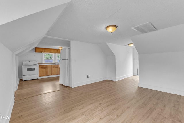 302 Hester St, Knightdale, NC 27545 - additional living space featuring lofted ceiling, light wood finished floors, and baseboards
