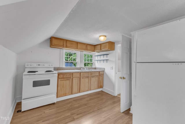 302 Hester St, Knightdale, NC 27545 - kitchen with white appliances, light wood-type flooring, light countertops, lofted ceiling, and a textured ceiling
