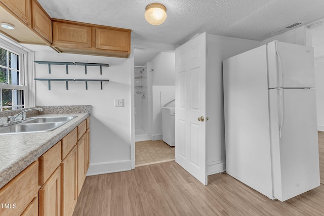 302 Hester St, Knightdale, NC 27545 - kitchen featuring freestanding refrigerator, a sink, light wood finished floors, light countertops, and open shelves