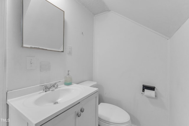 302 Hester St, Knightdale, NC 27545 - bathroom featuring vaulted ceiling, toilet, vanity, and a textured ceiling