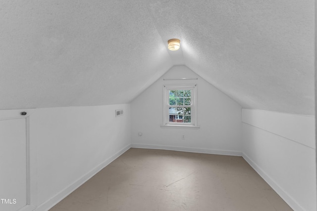302 Hester St, Knightdale, NC 27545 - bonus room featuring a textured ceiling, vaulted ceiling, and baseboards
