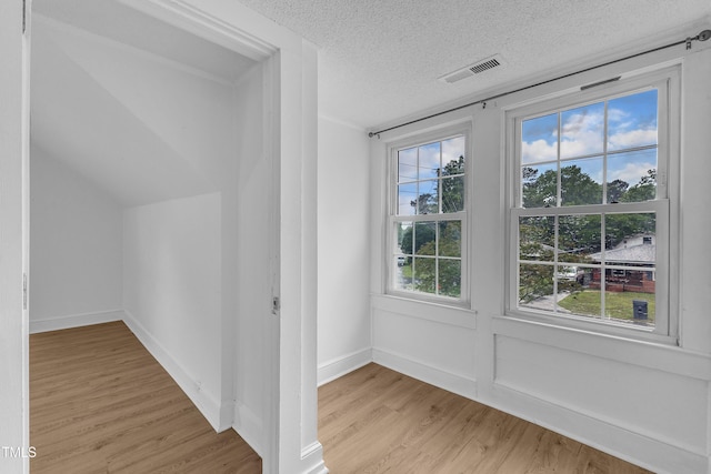302 Hester St, Knightdale, NC 27545 - additional living space featuring light wood finished floors, a textured ceiling, and baseboards