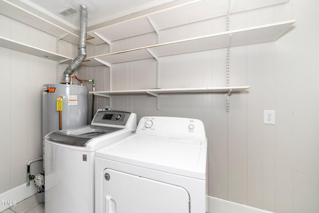 washroom with independent washer and dryer and water heater