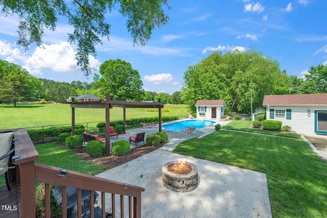view of yard with a fire pit, a patio area, and an outbuilding