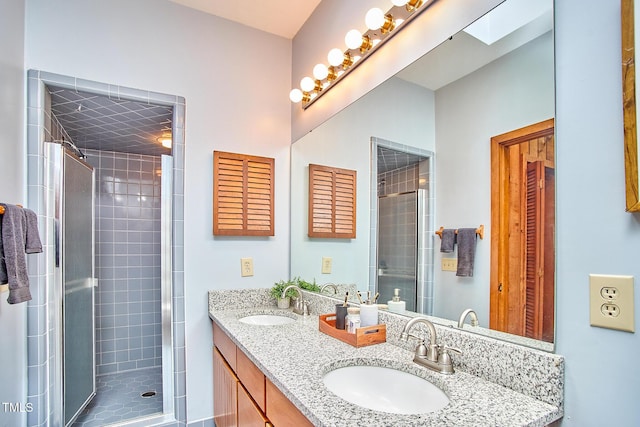 full bath featuring a stall shower and double vanity