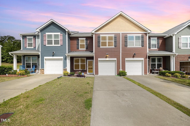 3403 Cardinal Lake Dr, Durham, NC 27704 - townhome / multi-family property with driveway, an attached garage, a yard, and stone siding