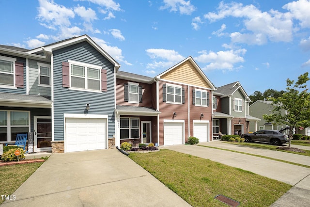 3403 Cardinal Lake Dr, Durham, NC 27704 - townhome / multi-family property with concrete driveway, an attached garage, a front yard, a residential view, and stone siding