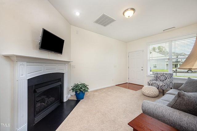 3403 Cardinal Lake Dr, Durham, NC 27704 - living area featuring a fireplace with flush hearth, baseboards, dark carpet, and vaulted ceiling