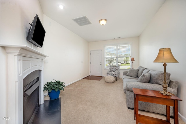 3403 Cardinal Lake Dr, Durham, NC 27704 - living area with carpet floors, baseboards, and a fireplace