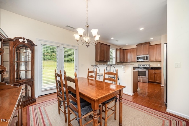 3403 Cardinal Lake Dr, Durham, NC 27704 - dining area with a chandelier, dark wood-style floors, and recessed lighting