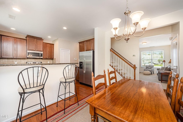 3403 Cardinal Lake Dr, Durham, NC 27704 - dining room featuring stairway, light wood finished floors, recessed lighting, and a chandelier