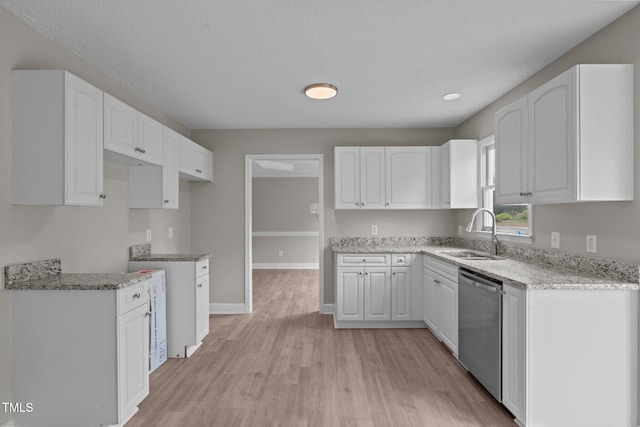 114 Lynnville Ct, Lillington, NC 27546 - kitchen featuring stainless steel dishwasher, a sink, white cabinetry, light wood-style flooring, and light stone countertops