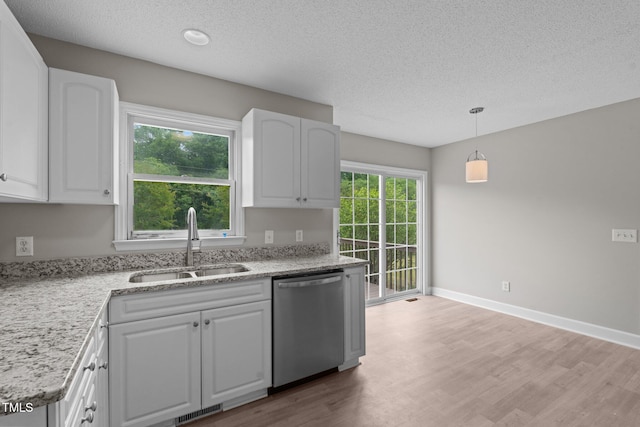 114 Lynnville Ct, Lillington, NC 27546 - kitchen featuring dishwasher, a sink, a textured ceiling, light wood-style floors, and white cabinetry