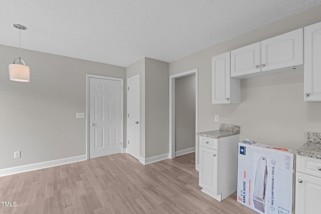 114 Lynnville Ct, Lillington, NC 27546 - kitchen with light wood finished floors, white cabinetry, baseboards, light stone counters, and pendant lighting