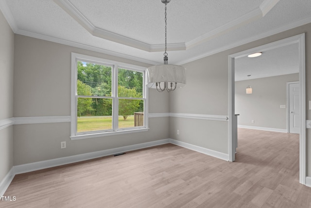 114 Lynnville Ct, Lillington, NC 27546 - spare room featuring a tray ceiling, ornamental molding, plenty of natural light, a textured ceiling, and light wood-style floors