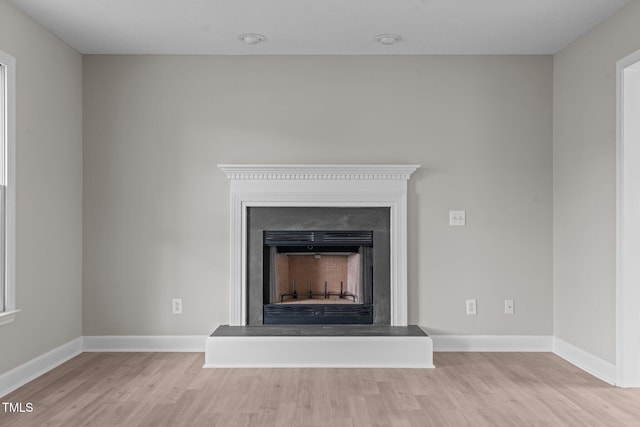 114 Lynnville Ct, Lillington, NC 27546 - detailed view of wood finished floors, a fireplace with raised hearth, and baseboards