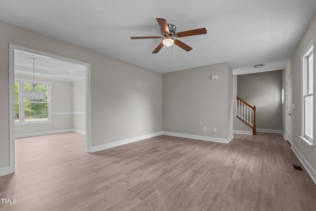 114 Lynnville Ct, Lillington, NC 27546 - empty room with light wood-type flooring, stairs, ceiling fan, and baseboards