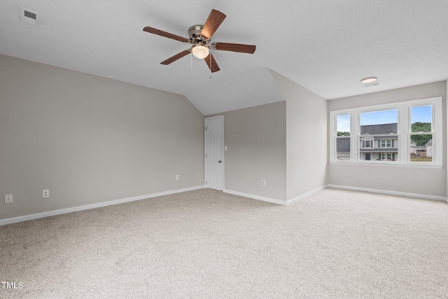 114 Lynnville Ct, Lillington, NC 27546 - carpeted spare room featuring baseboards, ceiling fan, and vaulted ceiling