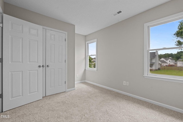 114 Lynnville Ct, Lillington, NC 27546 - unfurnished bedroom featuring carpet flooring, baseboards, and a closet