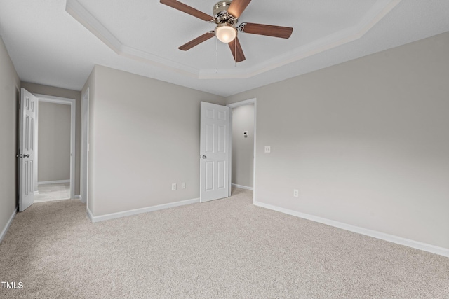 114 Lynnville Ct, Lillington, NC 27546 - unfurnished bedroom with a tray ceiling, carpet floors, baseboards, ornamental molding, and a ceiling fan