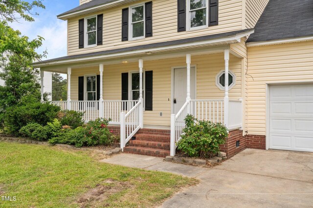 114 Lynnville Ct, Lillington, NC 27546 - doorway to property featuring covered porch, a lawn, and roof with shingles