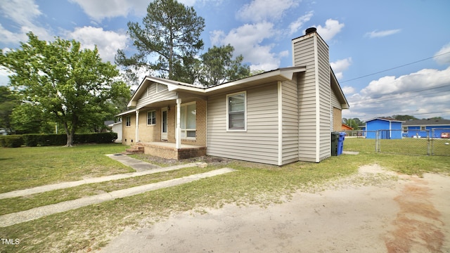 2121 Lombardy Dr, Fayetteville, NC 28304 - view of front of property featuring a chimney, brick siding, and covered porch