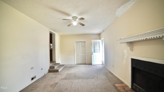 2121 Lombardy Dr, Fayetteville, NC 28304 - unfurnished living room with a ceiling fan, carpet floors, a fireplace, baseboards, and a textured ceiling