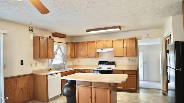 2121 Lombardy Dr, Fayetteville, NC 28304 - kitchen featuring electric range, white dishwasher, under cabinet range hood, freestanding refrigerator, and a sink