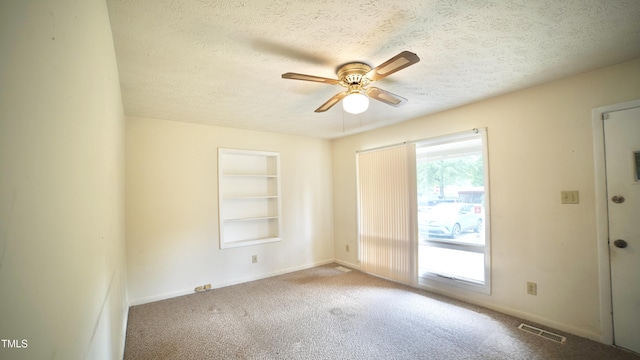 2121 Lombardy Dr, Fayetteville, NC 28304 - carpeted spare room with a textured ceiling, a ceiling fan, baseboards, and built in shelves
