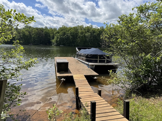 dock featuring a water view and a forest view