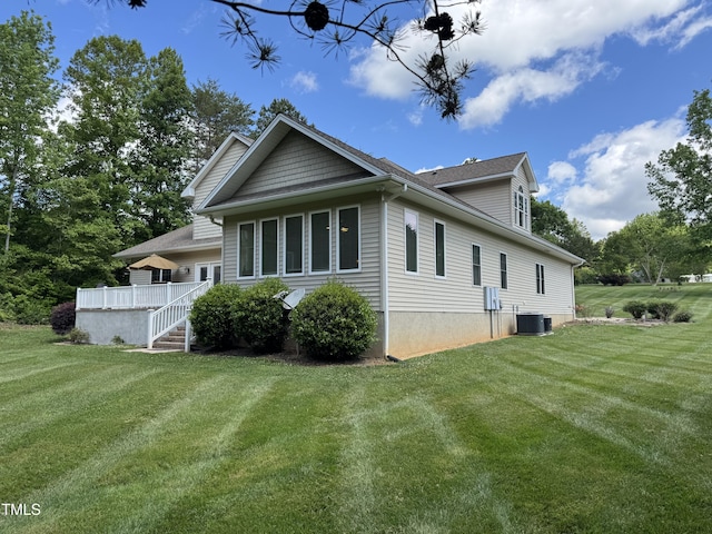 view of property exterior featuring central AC and a yard