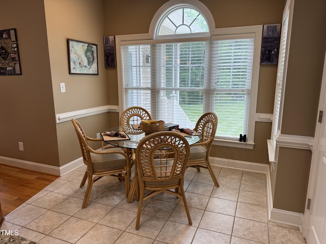 dining room with baseboards and light tile patterned floors